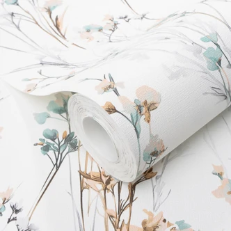 Ikke-vævet tapet med sarte engblomster i mint-abrikos som blomstret naturtapet Ikke-vævet tapet med sarte engblomster i mint-abrikos som blomstret naturtapet