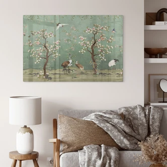 Glasbild Kraniche in floraler Landschaft - Bloomery Decor Glasbild Kraniche in floraler Landschaft - Bloomery Decor