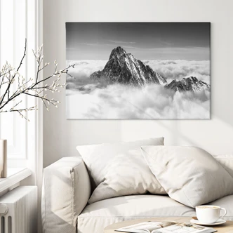 Leinwandbild Bergspitze über den weißen Wolken 