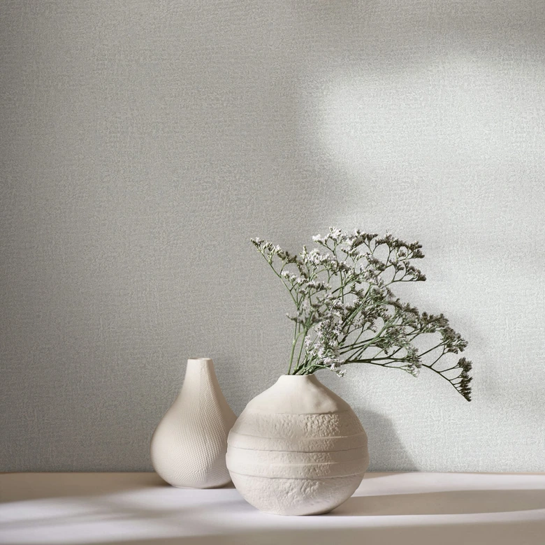 Non-woven tapet i grått, vit texturerad textil i putsutseende 