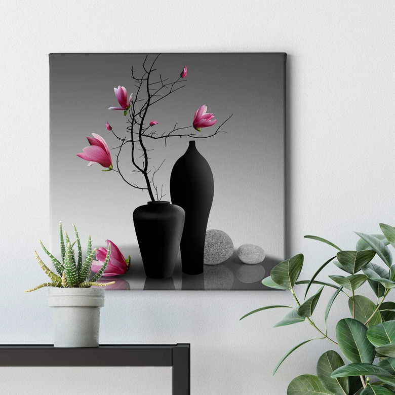 Tableau sur toile Branche de magnolia dans un vase noir 